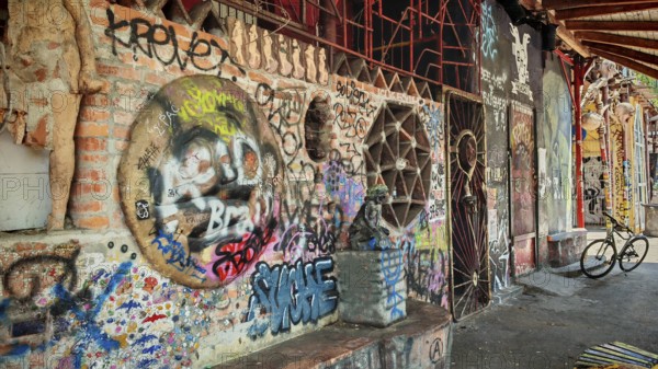 A mix of graffiti, art and bicycles on an urban brick wall with colors, Ljubljana, Slovenia