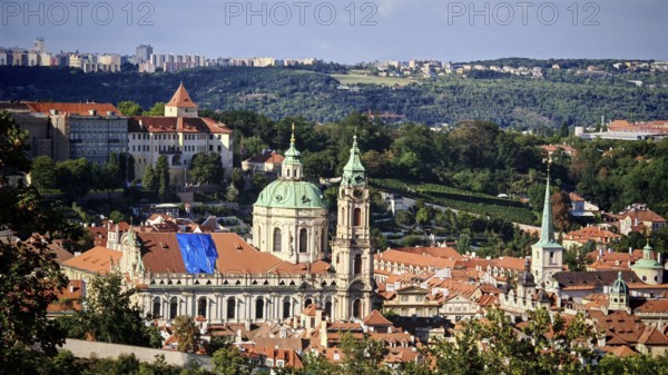 View of a Baroque church and surrounding cityscape with sunny sky, Prague, Czech Republic