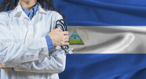 Healthcare professional with Nicaragua flag background. Professional doctor holding stethoscope on