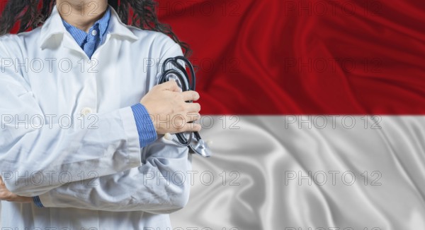 Healthcare professional with Monaco flag background. Professional doctor holding stethoscope on
