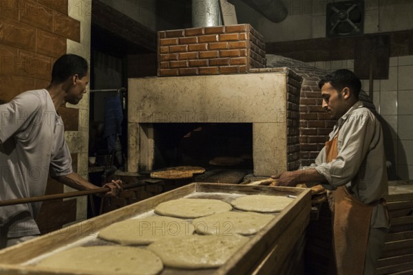 Tripoli, Libya, North Africa. Making traditional pita bread in an old bakery in the historic part