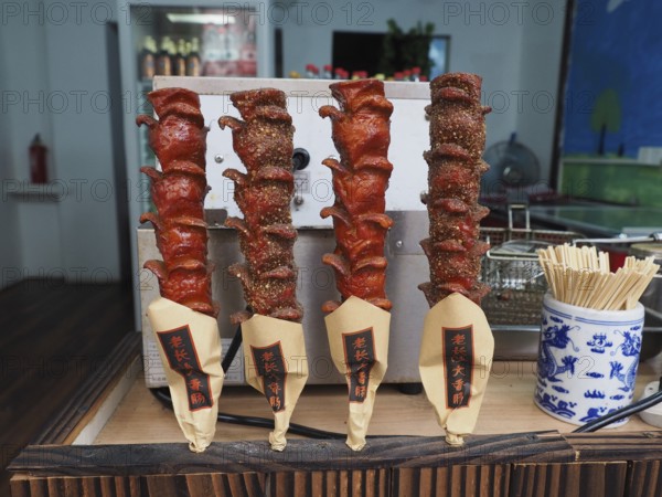 Various spiced meat skewers are presented at a street food market, Zhujiajiao Ancient Town,