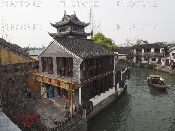 A Chinese-style building on the banks of a canal on a traditional boat, Zhujiajiao Ancient Town,
