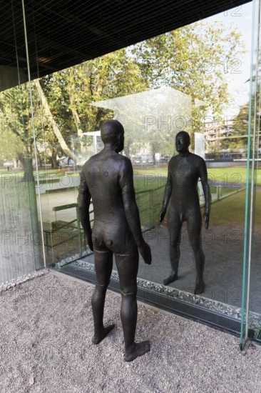 Male figure looking at her real reflection, Reflections II sculpture by sculptor Antony Gormley,