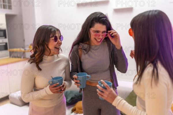 Three young women laughing and chatting at a cozy house party, holding drinks and enjoying a