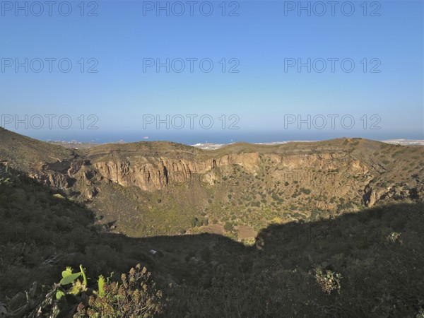 Caldera de Bandama volcanic crater overlooking the sea under a blue sky, Gran Canaria, Canary