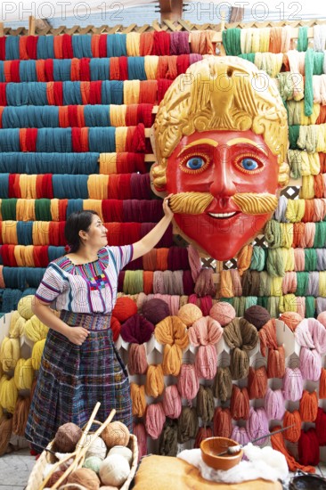 Maya woman, 42 years old, looks at the mask of a Moro or Moor for the traditional mask dance,