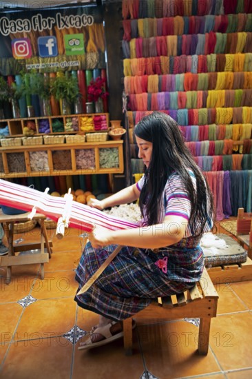 Maya woman, 42 years old, weaving with a back strap, traditional craft in a woman's cooperative,