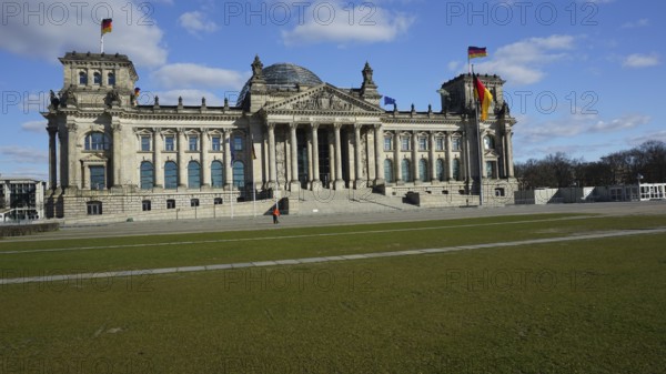 Historic building, Reichstag, Bundestag with dome and German flags on a sunny day, without people,