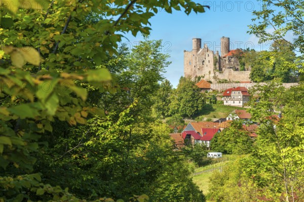 View of the ruins of Hanstein Castle and the small village of Rimbach with half-timbered houses,