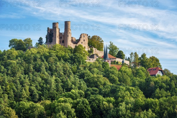 View of the ruins of Hanstein Castle and the small village of Rimbach, village church with