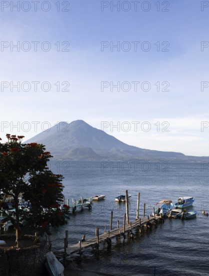 Boats on the dock, Lake Atitlán or Lake Atitlán in the morning, the volcanoes Atitlán and Toliman
