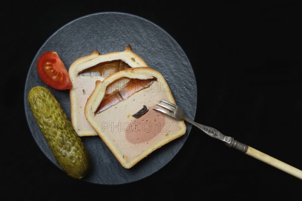 Battered pate on plate with cucumber and tomato