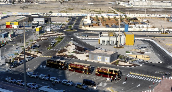 Taxi and hop on hop off buses are waiting for tourists in the cruise terminal parking lot, Abu