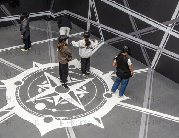 Visitors wearing VAR glasses at Louvre Abu Dhabi, art museum by French architect Jean Nouvel,