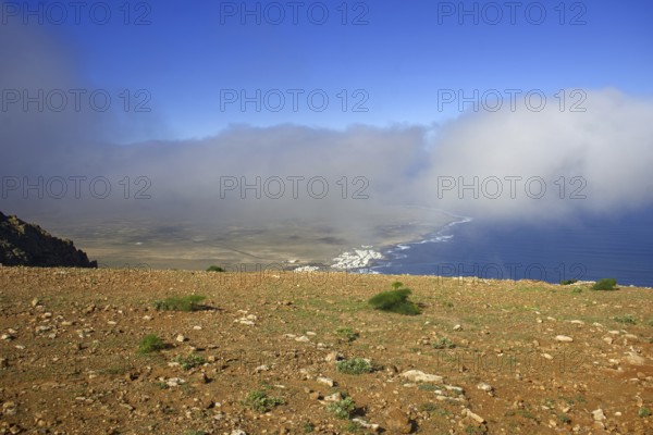 Wide view from Mirador de Ermita de Las Nieves of the coastal village of Caleta de Famara with