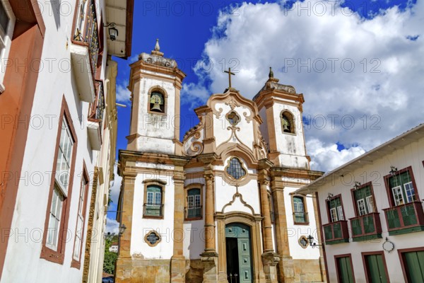 Baroque cathedral facade surrounded by old houses in the historic city of Ouro Preto, Ouro Preto,