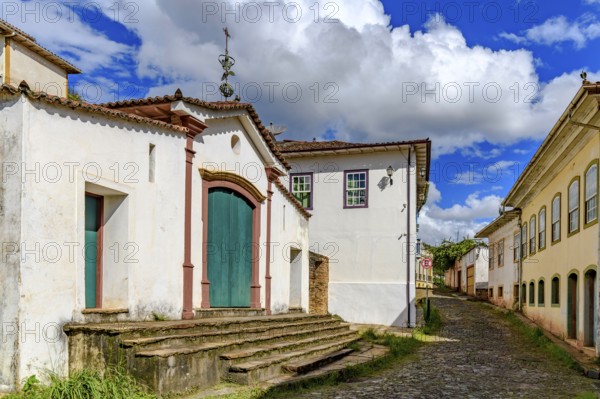 Historic chapel on a cobblestone street and old colonial houses in Ouro Preto, Ouro Preto, Minas