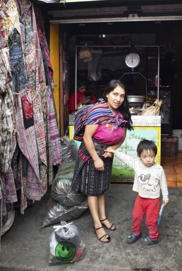 Mayan woman with toddler in traditional clothes at the market in Chichicastenango, Highlands, El