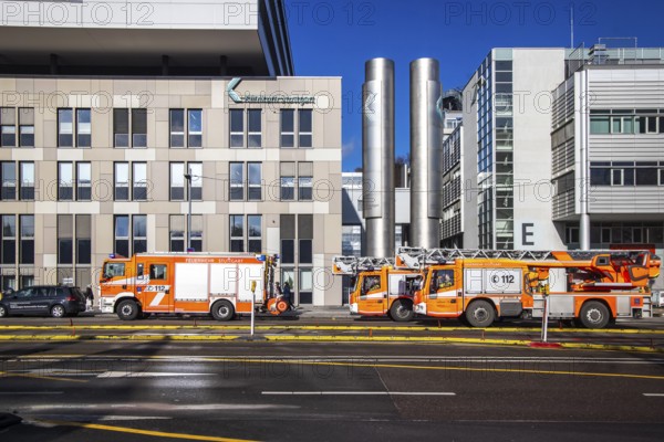 Fire service at Stuttgart Hospital. Fire trucks are parked in front of the building following a