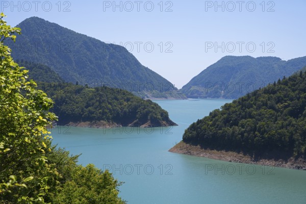 Large, calm lake surrounded by forested mountains, Jvari Reservoir, Enguri River, Mingrelia region