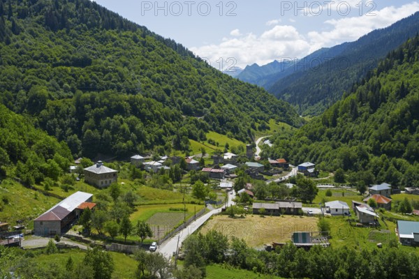 Village nestled in a green valley with mountains in the background, Bogreshi, road 7, Mingrelia and