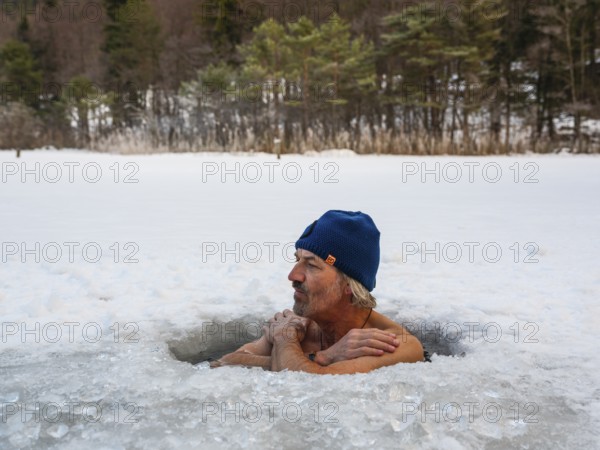 Man with cap, 55, ice bathing in an ice hole, Thumsee, Bad Reichenhall, Berchtesgadener Land, Upper