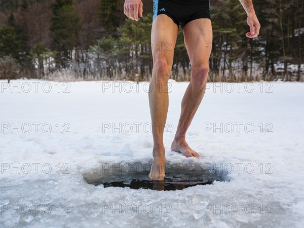 Naked men's legs at an ice hole, toes in water, Thumsee, Bad Reichenhall, Berchtesgadener Land,