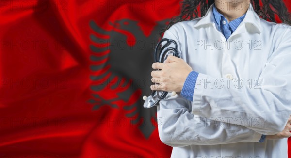 Healthcare professional with Albania flag background. Professional doctor holding stethoscope on