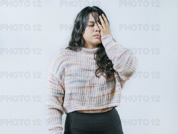 Exhausted young woman putting the palm on his face isolated. Tired and exhausted person covering