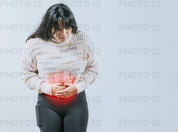 Female person holding stomach with digestive problems isolated. Sore Asian woman with digestive