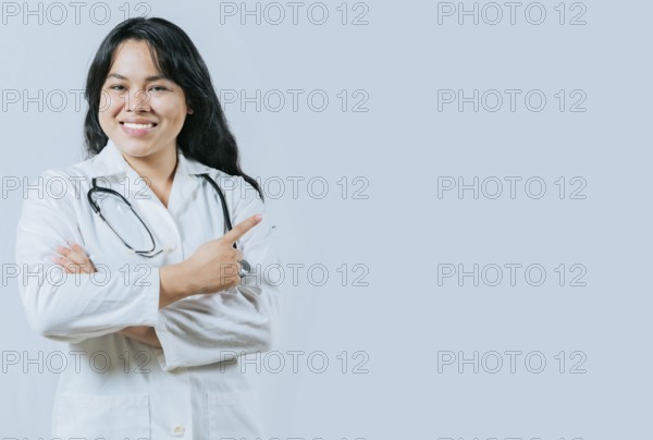 Smiling asian female doctor recommending an advertisement. Asian young doctor pointing to the side