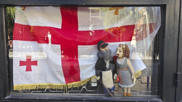 Shop window with traditional Georgian dolls and flag, Georgia