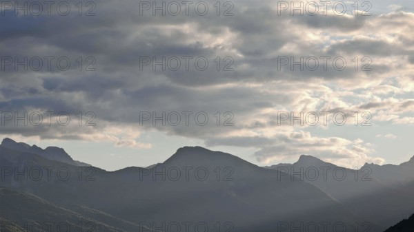 A quiet mountain panorama with clouds in subtle lighting, Montenegro