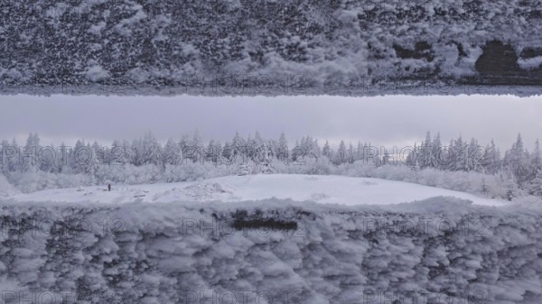 Snowy landscape with views of a forest from the viewpoint. Quiet, cold atmosphere, Schneeberg,