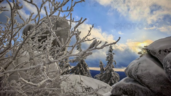 Snowy rocks and trees with a dramatic evening sky, Fichtelgebirge, Bavaria