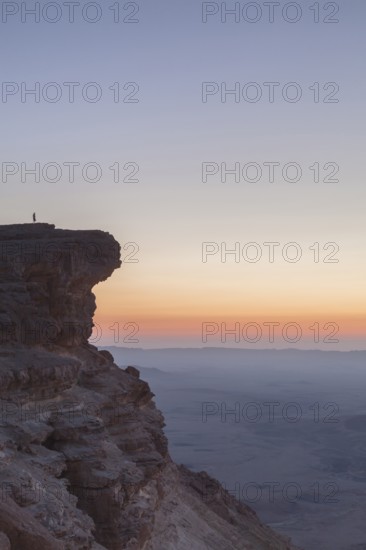 Mitzpe Ramon, Israel, Negev Desert, A woman in the vast overlooking the vast Makhtesh Ramon crater
