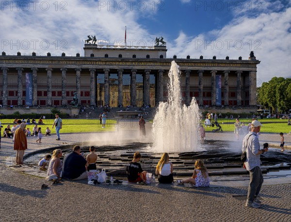 Water fountain, summer lifestyle, tourists and passers-by in the pleasure garden in Berlin-Mitte,