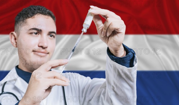 Doctor holding syringe on Netherlands flag background. Medical professional holding syringe with