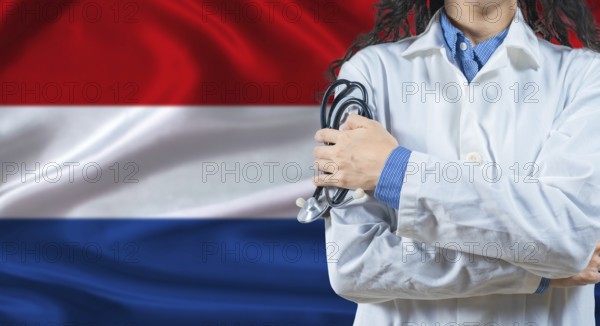 Healthcare professional with Netherlands flag background. Professional doctor holding stethoscope