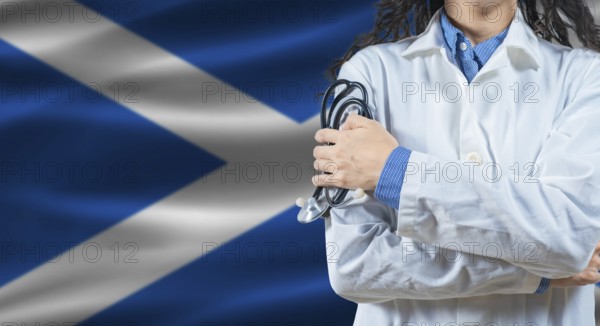 Healthcare professional with Scotland flag background. Professional doctor holding stethoscope on
