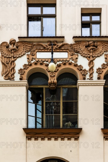 Czyncielow Art Nouveau house façade with intricate terracotta reliefs depicting snakes and an