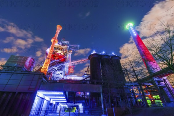Bright and colorful lighting of an industrial plant at night, Landschaftspark Duisburg Nord,