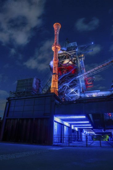 Futuristic industrial plant in glowing night light, Landschaftspark Duisburg Nord, Duisburg, North
