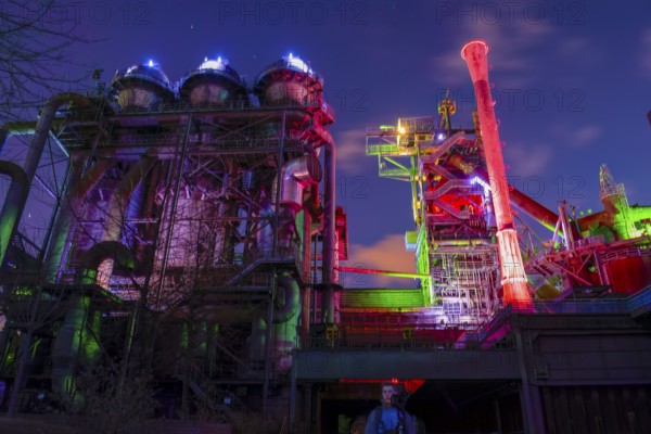 Industrial plant illuminated in colorful lights at night, Landschaftspark Duisburg Nord, Duisburg,