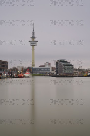 View across a harbor basin to the radar tower in Bremerhaven, Bremen, Germany