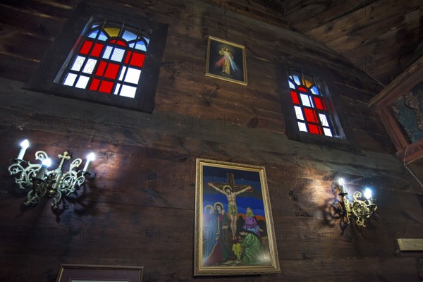 Colored stained glass windows in the historic wooden Trinity Church, Zhovkva city, Ukraine