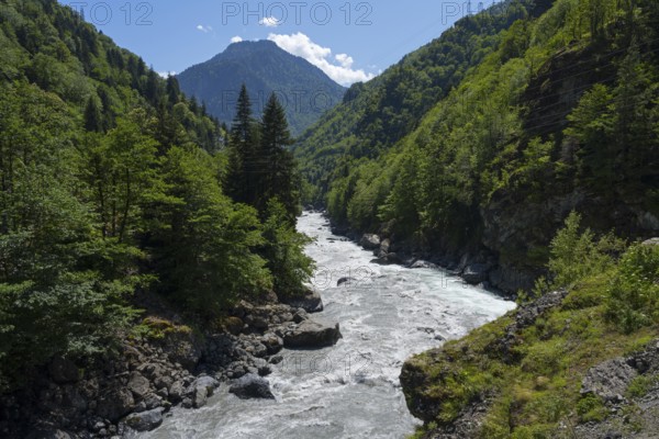 A picturesque river snakes through a wooded valley, Enguri River near Khaishi, Mingrelia region and