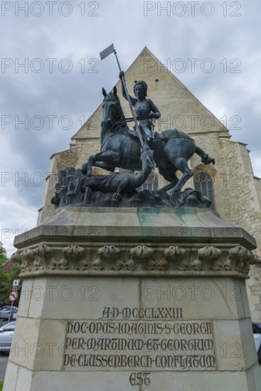 Sculpture of Saint George with dragons, in the back the Reformed Church in Wolfsgasse, Cluj-Napoca,