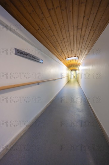 Long corridor with wooden ceiling and sign, soft lighting, fibreglass groundbreaking, Freudenstadt,